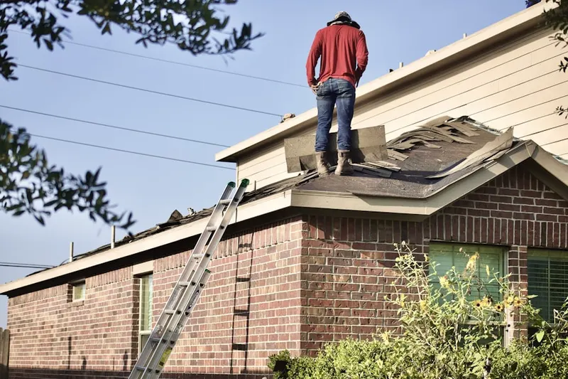 Professional roofer working on a residential roof in Dalevue